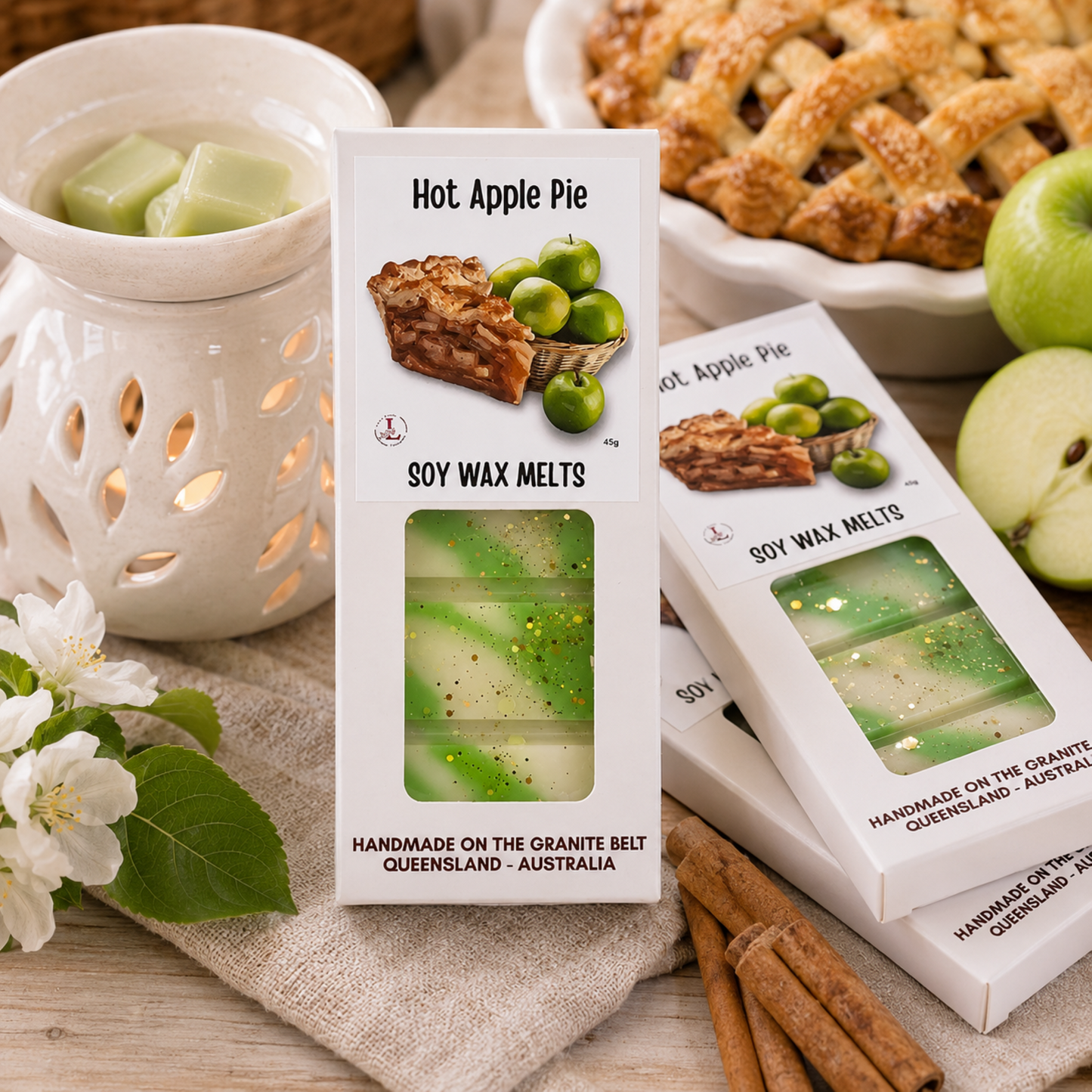 Handmade Hot Apple Pie soy wax melts by Lee's Little Luxuries in a 45g gift box with apple pie and green apple artwork. Australian-made natural soy wax melts displayed in premium window packaging, offering the warm, comforting aroma of freshly baked apple pie with sweet apples, cinnamon and buttery pastry for home fragrance.