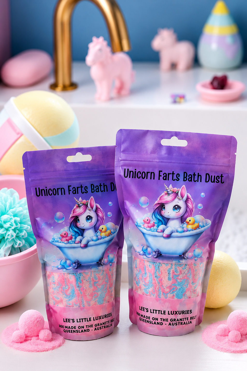 Unicorn Farts Bath Dust pouches with colourful pink and blue bath dust, displayed in a pastel bathroom setting