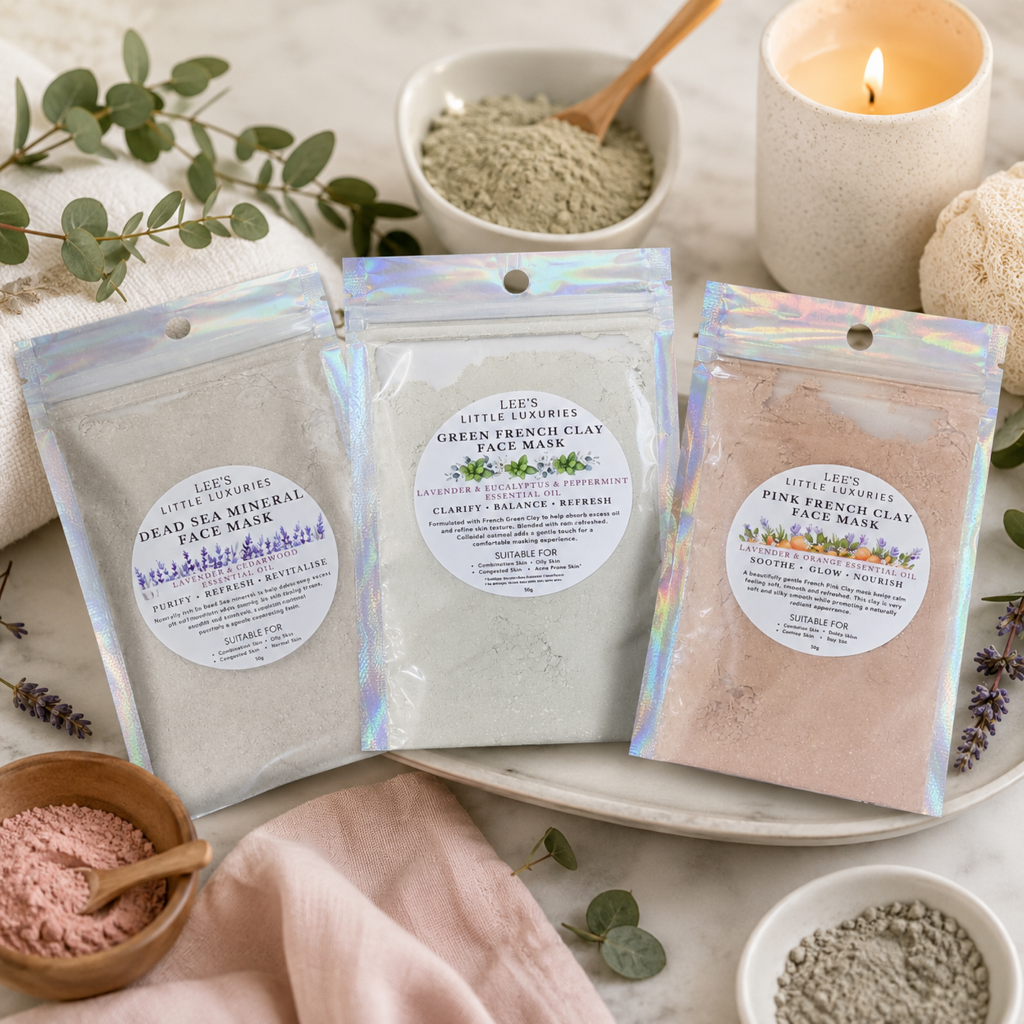 Mixed Face Masks in a relaxing spa setting with eucalyptus leaves, lavender sprigs, clay powder and a lit candle.