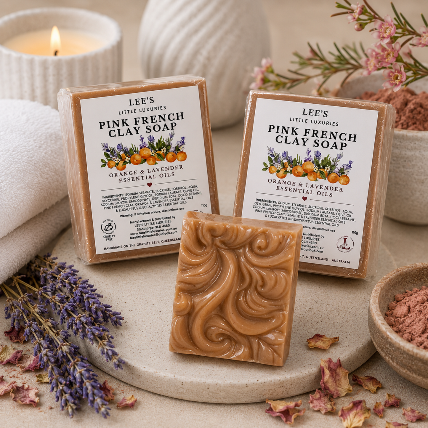 Pink French Clay Spa Soap displayed in a luxury spa setting with rolled towels, candles and lavender