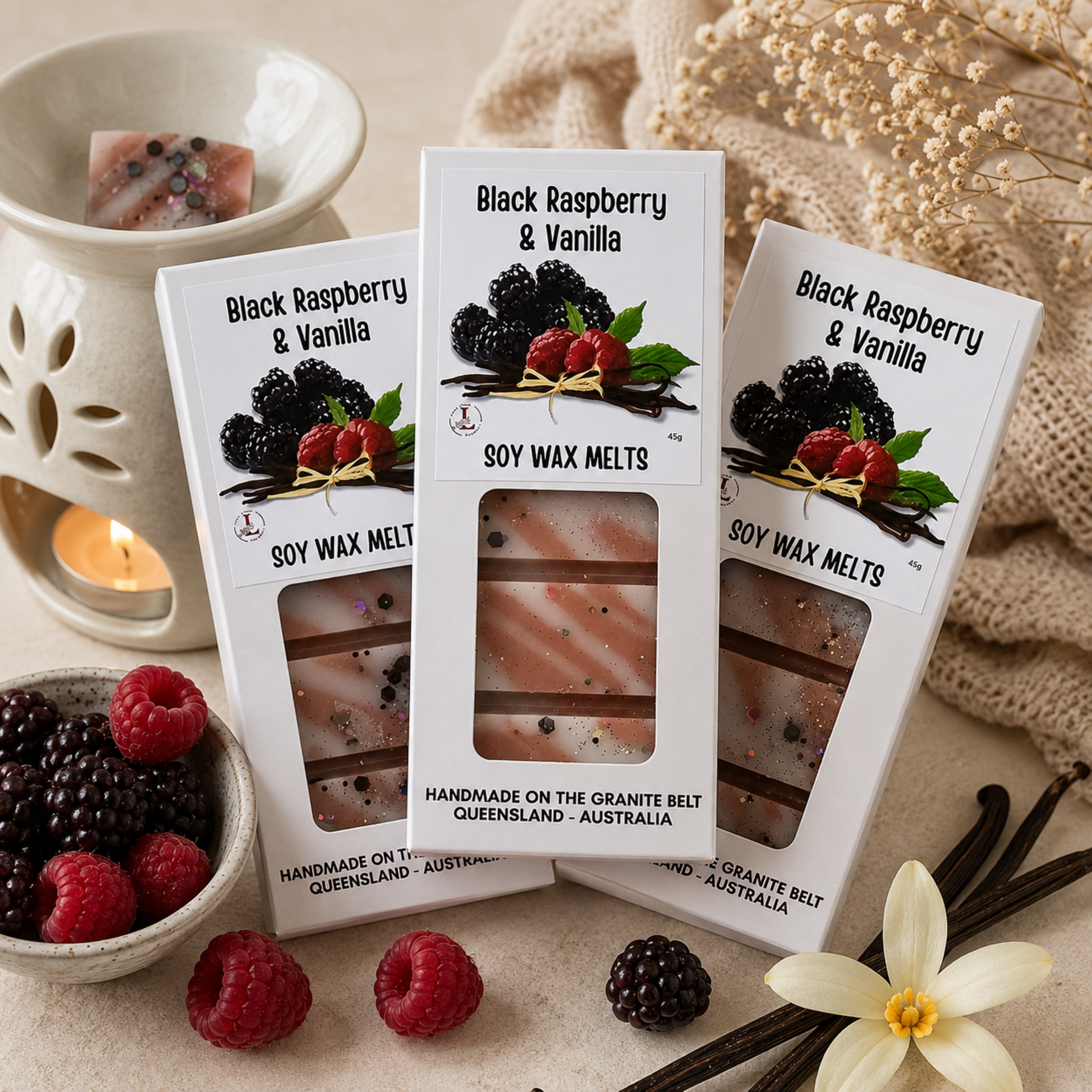 Luxury Black Raspberry & Vanilla Soy Wax Melts by Lee's Little Luxuries displayed with a ceramic wax burner, fresh blackberries, raspberries and vanilla pods in a cosy home setting, handmade on the Granite Belt, Queensland, Australia.